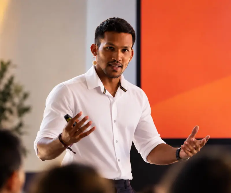 Neil Ateem presenting on stage